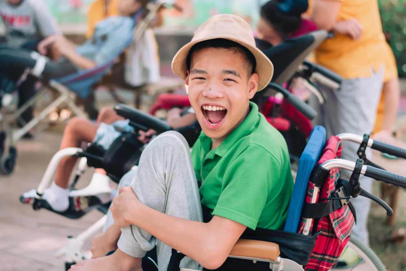 A young participant smiling at a group community activity