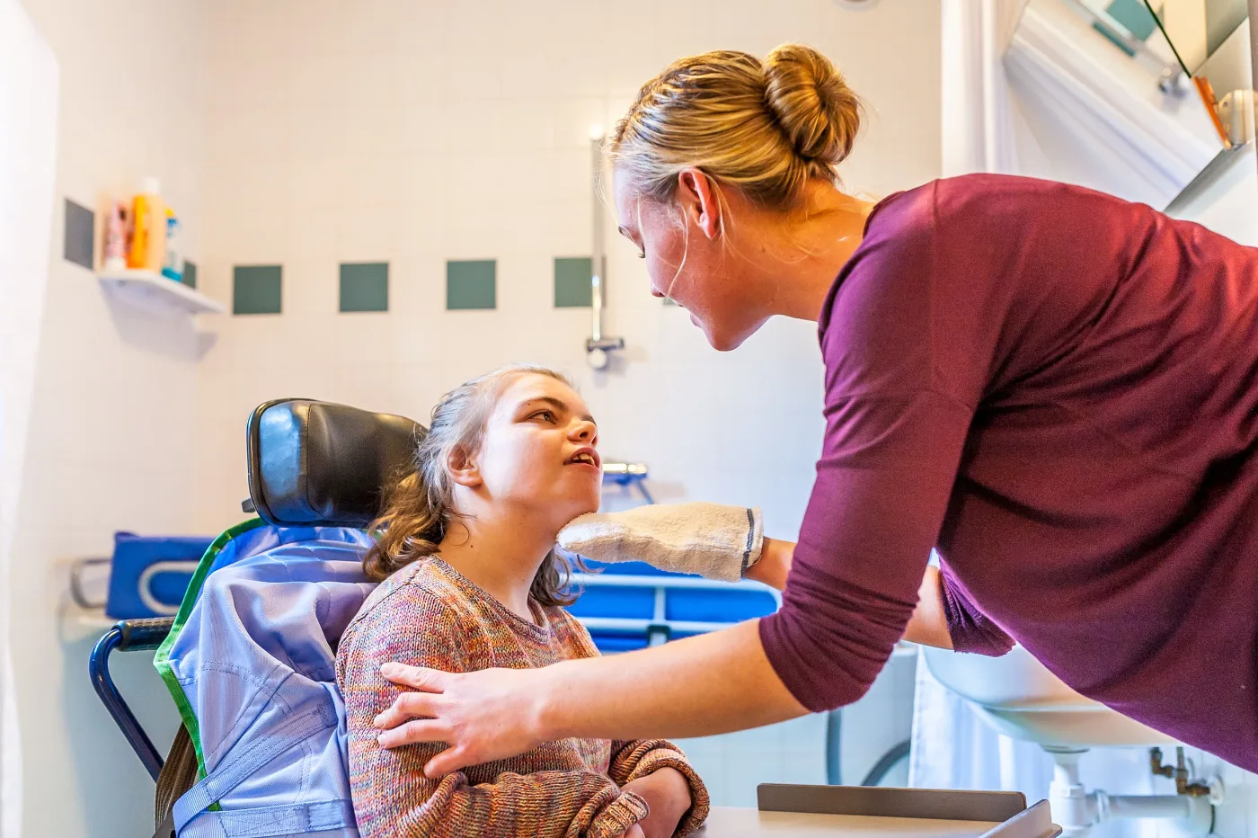 A support worker assisting a participant at home
