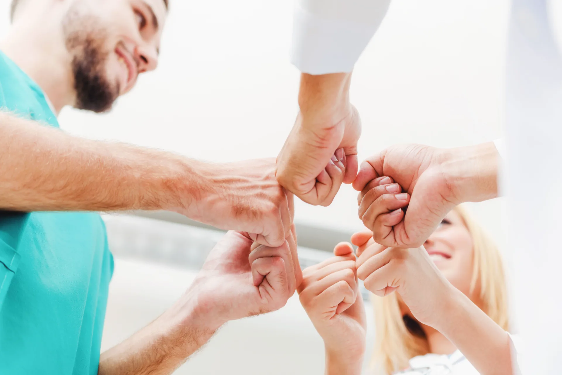 Members of the support team putting their fists together